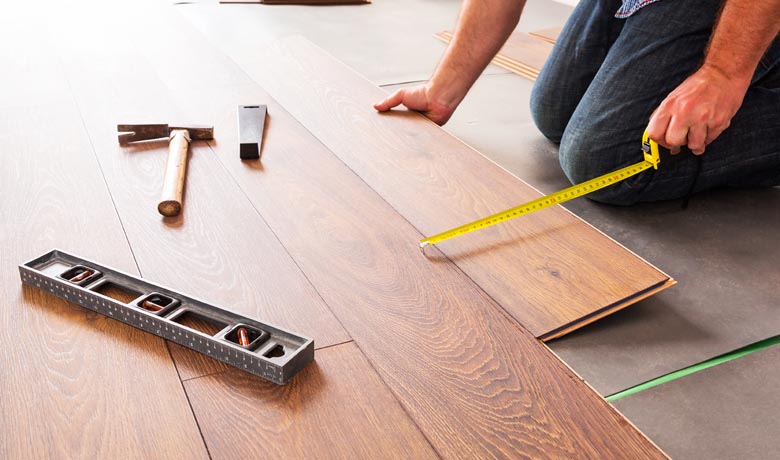 Man installing new laminated wooden floor