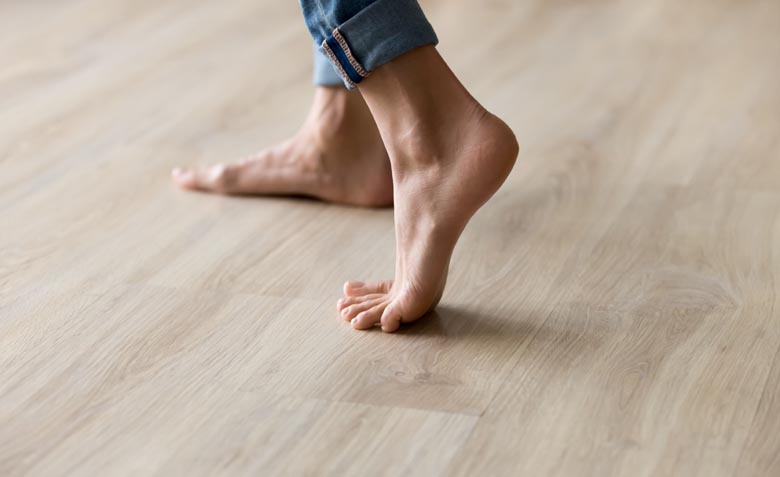 a person walking on laminate flooring