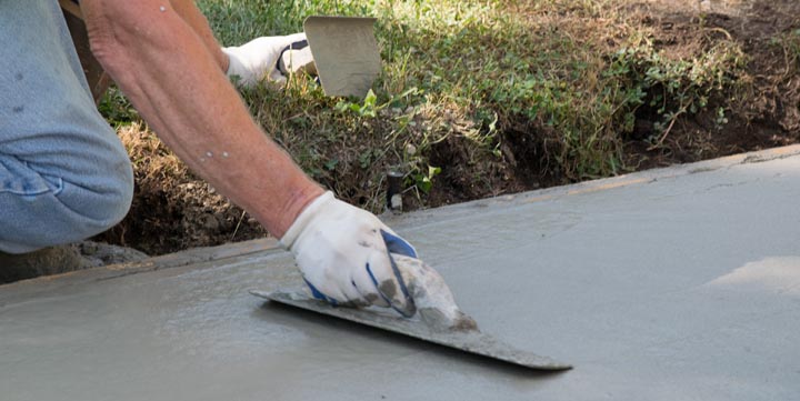 Man Pouring and Finishing a Concrete Driveway