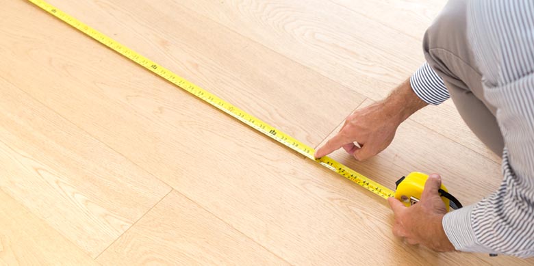 man measuring room for new flooring
